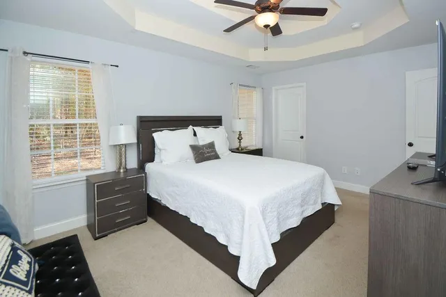 a bedroom with a bed and a chandelier