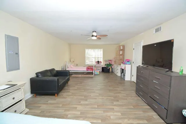 a living room with furniture and a flat screen tv