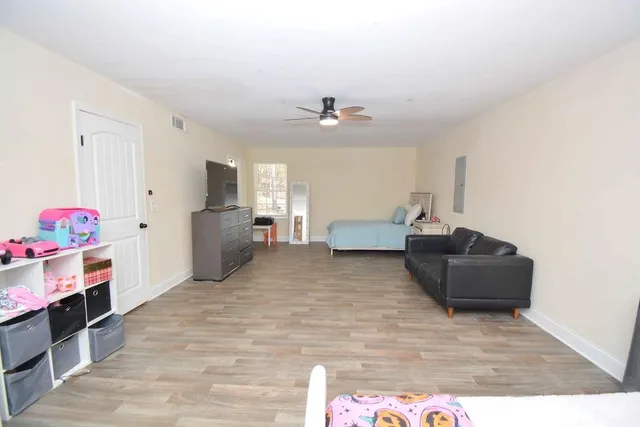 a living room with furniture and a dresser