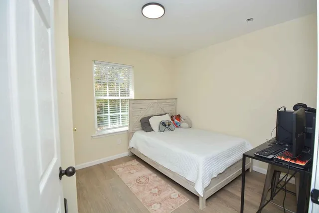 a bedroom with a bed and a window