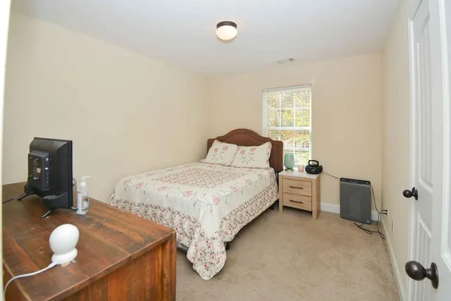 a bedroom with a bed and window