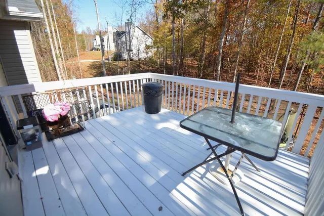 a view of a balcony with wooden floor