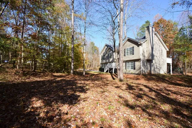 a view of a large white house with a snow on the road