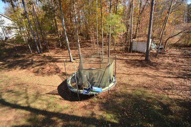a front view of a house with a yard covered with snow