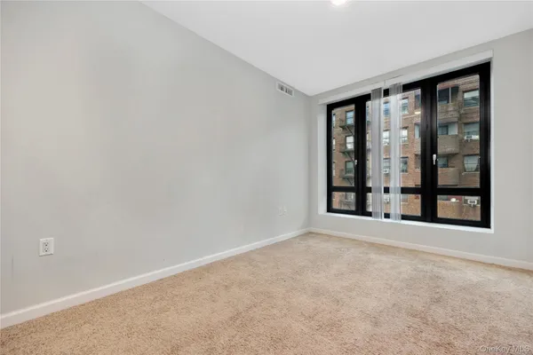 a bedroom with bed and large window