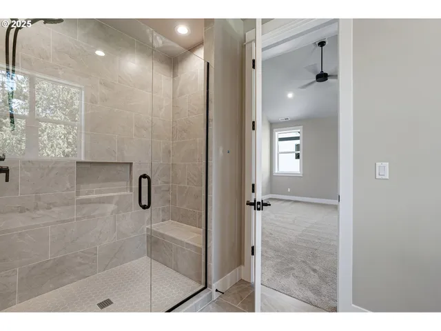 a bathroom with a glass shower door