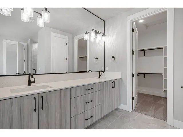 a bathroom with a double vanity sink and a mirror