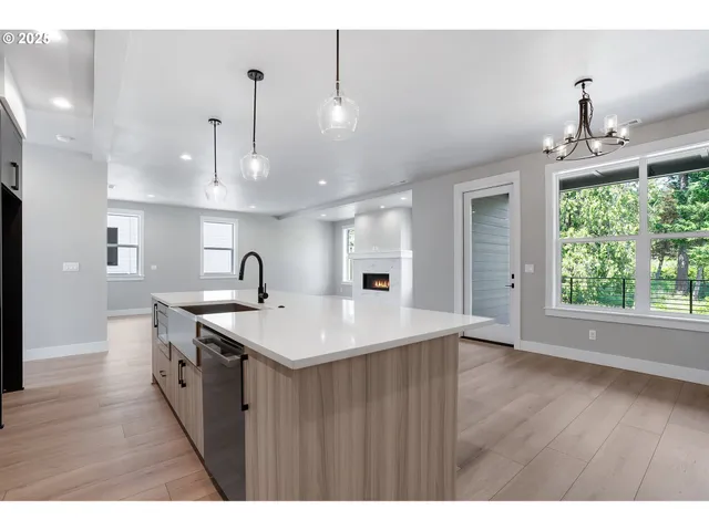 a kitchen with kitchen island a sink stainless steel appliances and cabinets