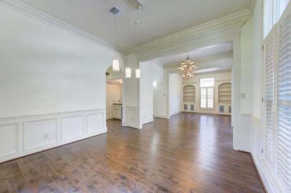 a view of a room with wooden floor