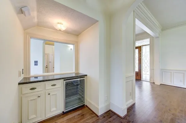 a hall with wooden floors and cabinet