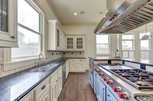 a kitchen that has a sink and a stove