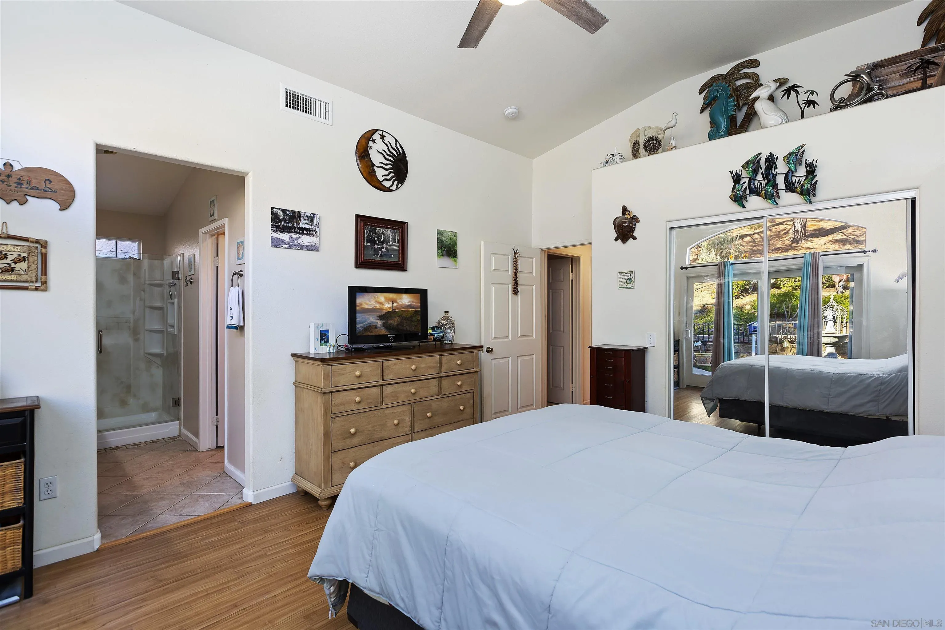 2644 Lobelia Road Alpine, CA 91901 - Photo 19 of 33 a bedroom with a bed and dresser with wooden floor