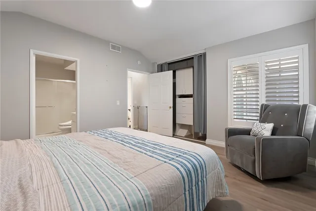 a bedroom with a bed and a couch