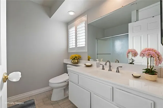 a bathroom with a sink a mirror and a toilet