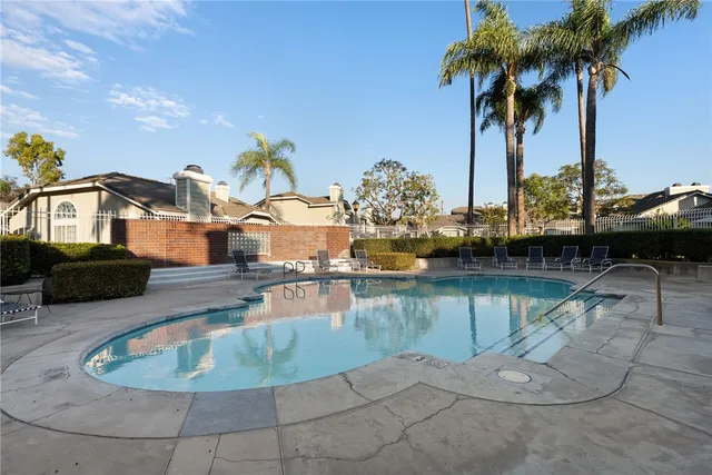 a swimming pool view with a sitting space