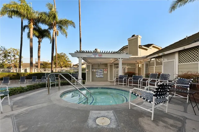 a view of a house with swimming pool and sitting area