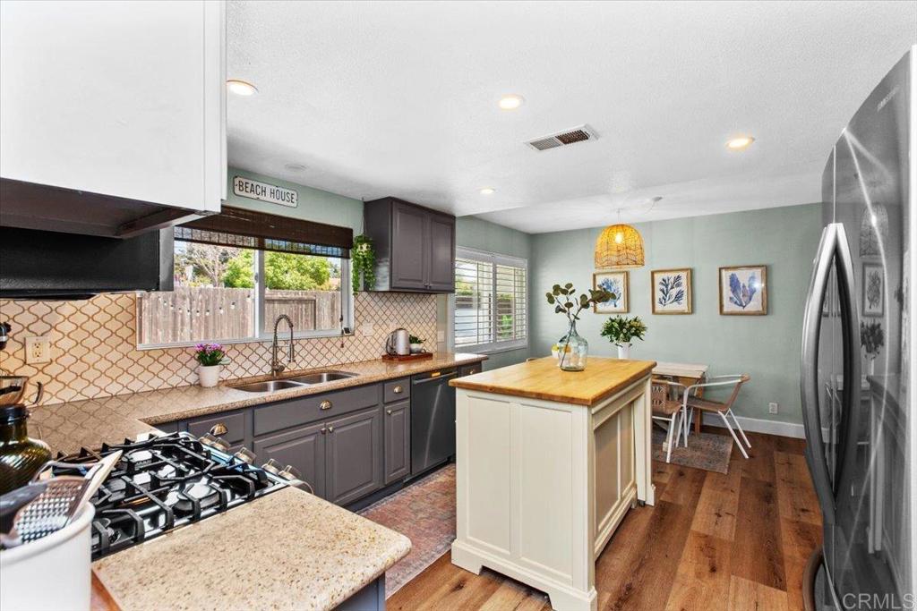 1480 Kurtz Street Oceanside, CA 92054 - Photo 14 of 31 a kitchen with stainless steel appliances granite countertop a sink stove and refrigerator