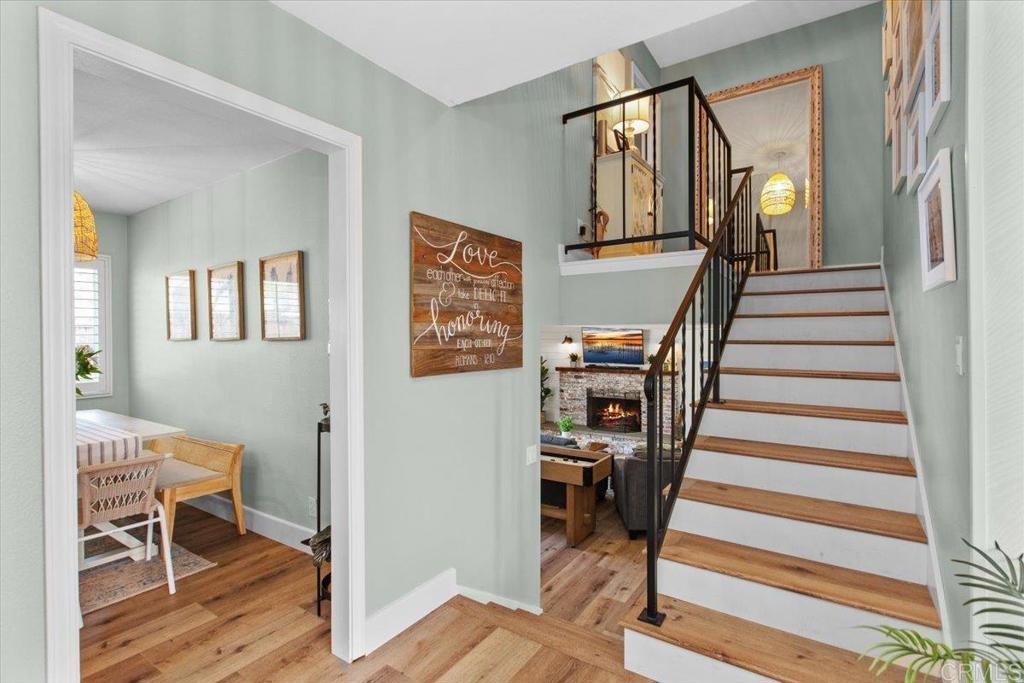 1480 Kurtz Street Oceanside, CA 92054 - Photo 17 of 31 a view of a hallway with wooden floor and stairs