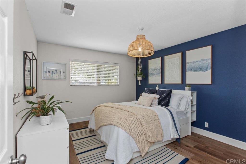 1480 Kurtz Street Oceanside, CA 92054 - Photo 18 of 31 a bedroom with bed and a chandelier