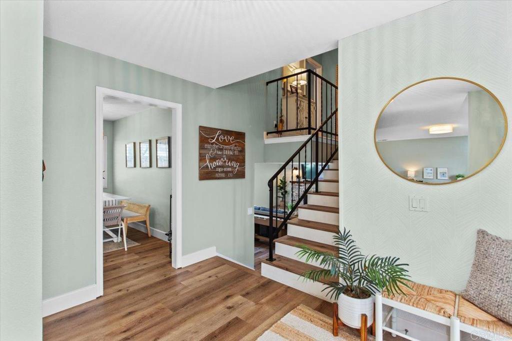1480 Kurtz Street Oceanside, CA 92054 - Photo 6 of 31 a view of a hallway with wooden floor staircase and a living room