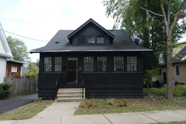 a front view of a house with a garden