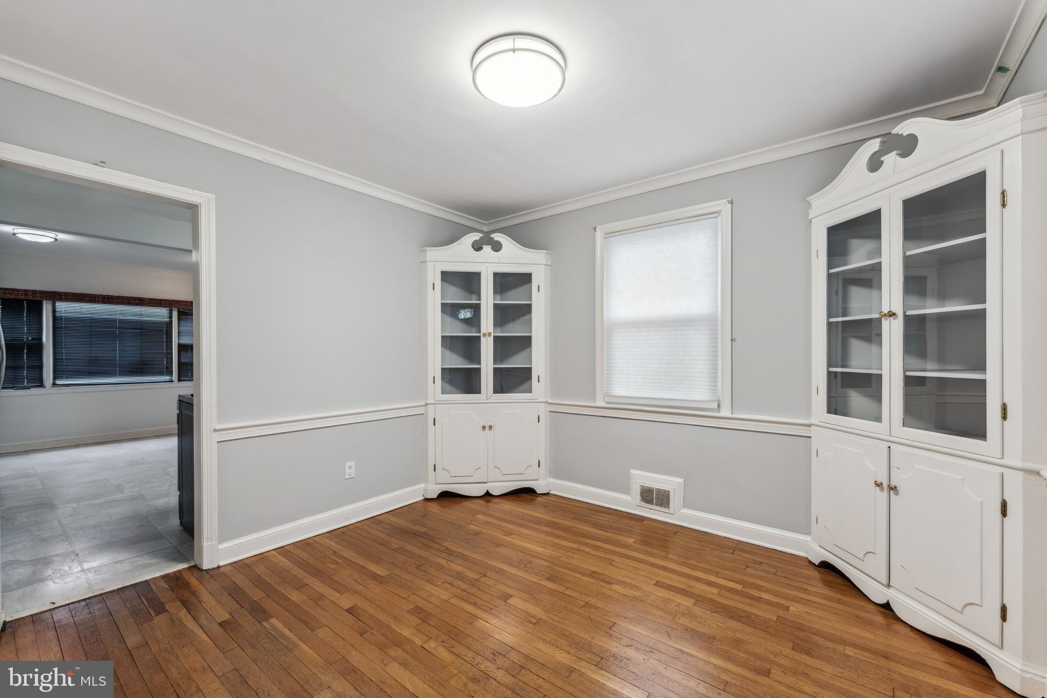 9222 Glenville Road Silver Spring, MD 20901 - Photo 4 of 15 wooden floor in an empty room with a window