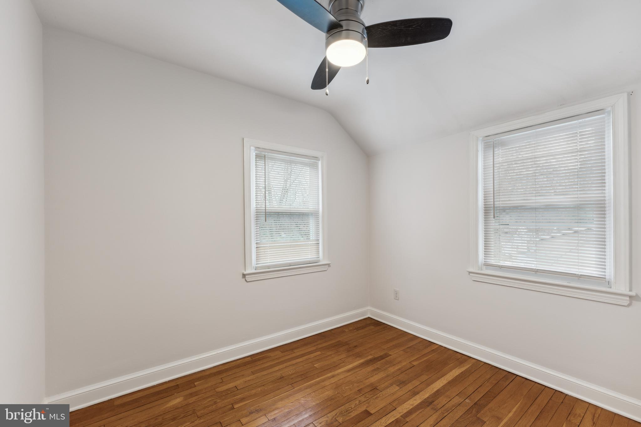 9222 Glenville Road Silver Spring, MD 20901 - Photo 6 of 15 an empty room with wooden floor and windows