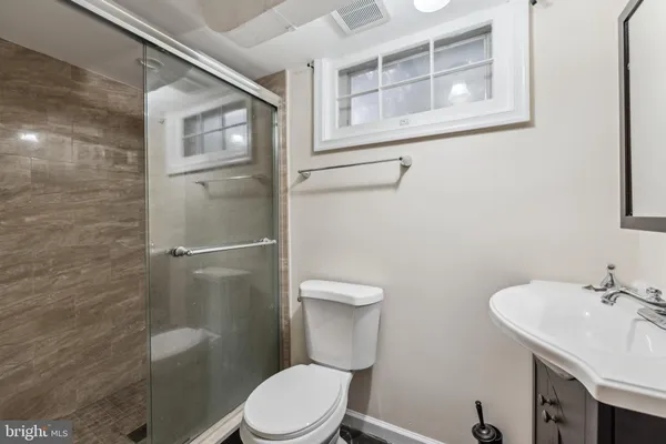 a white toilet sitting next to a bathroom sink