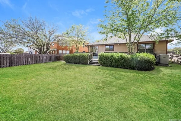 a view of a house with a yard and pathway