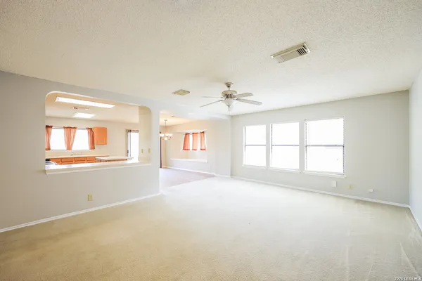 an empty room with a window and fireplace