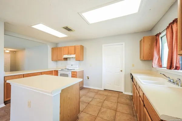 a view of a kitchen with a sink dishwasher and a refrigerator