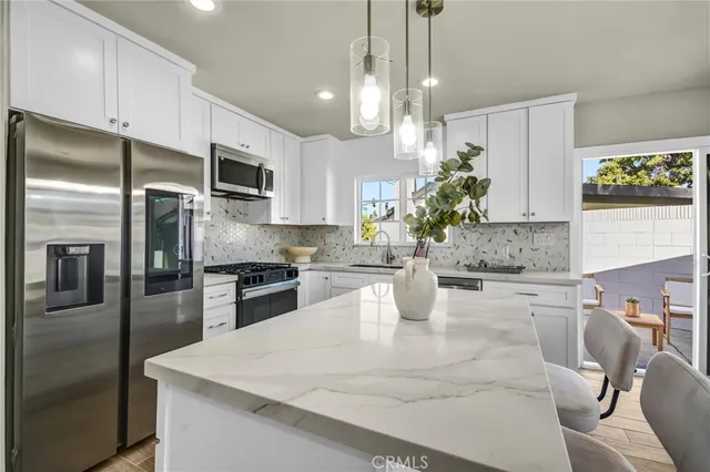 a kitchen with granite countertop a refrigerator oven a sink and dishwasher