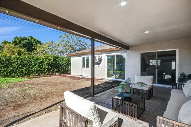 a outdoor space with patio the couches and dining table with garden view