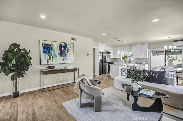 a living room with furniture and a kitchen view