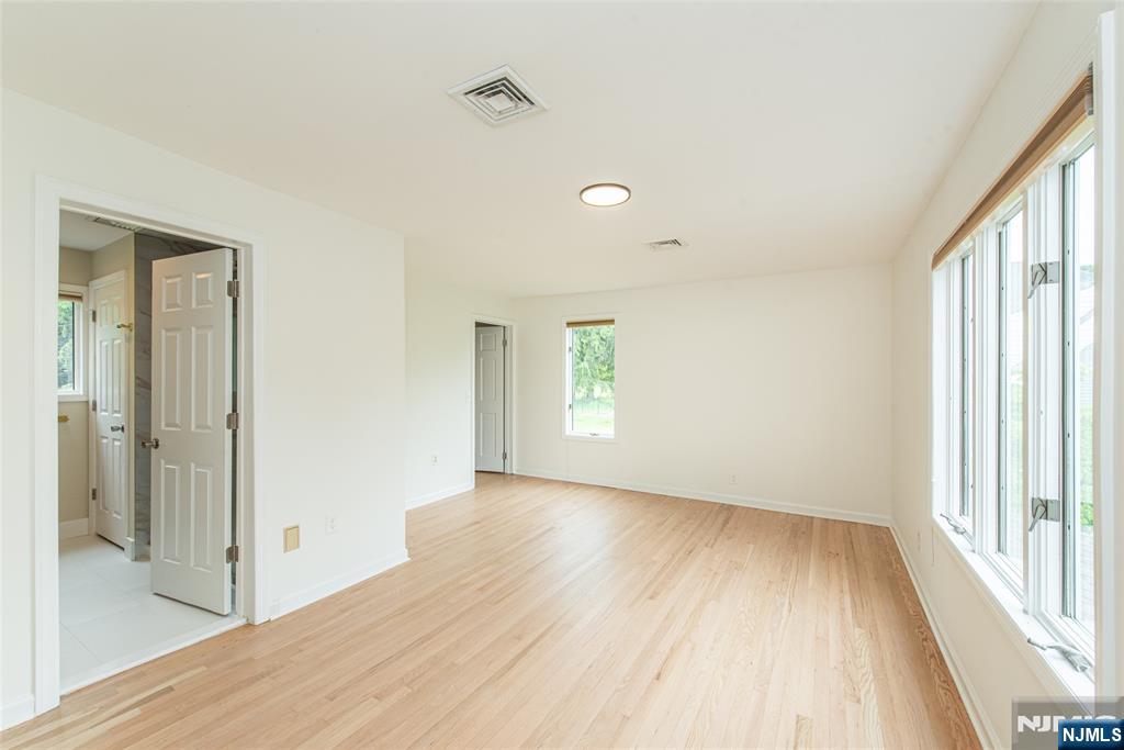 163 Sand Spring Road Morristown, NJ 07960 - Photo 20 of 39 a view of hallway with a large window and wooden floor