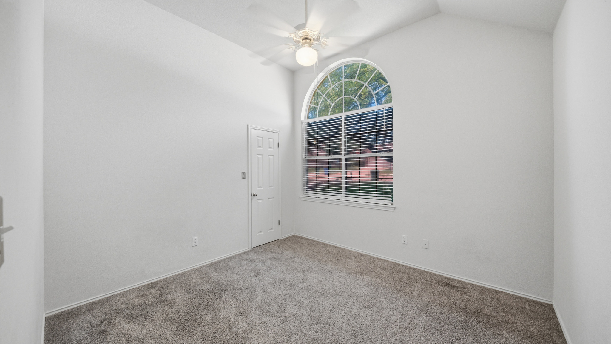 1108 Antelope Ridge Cedar Park, TX 78613 - Photo 13 of 27 A graceful arched window illuminates this comfortable carpeted bedroom, offering quiet and relaxation.