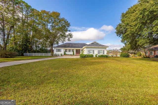 a front view of a house with a garden