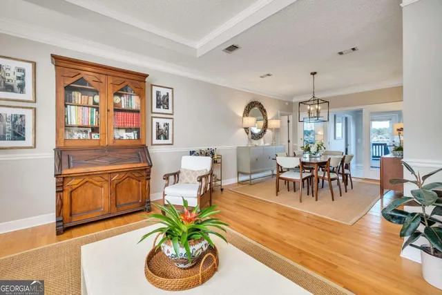 a living room with furniture a dining table and chairs