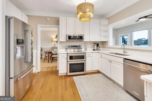 a kitchen with white cabinets and a sink