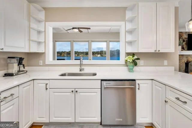 a kitchen with stainless steel appliances granite countertop a sink a stove and a wooden floors
