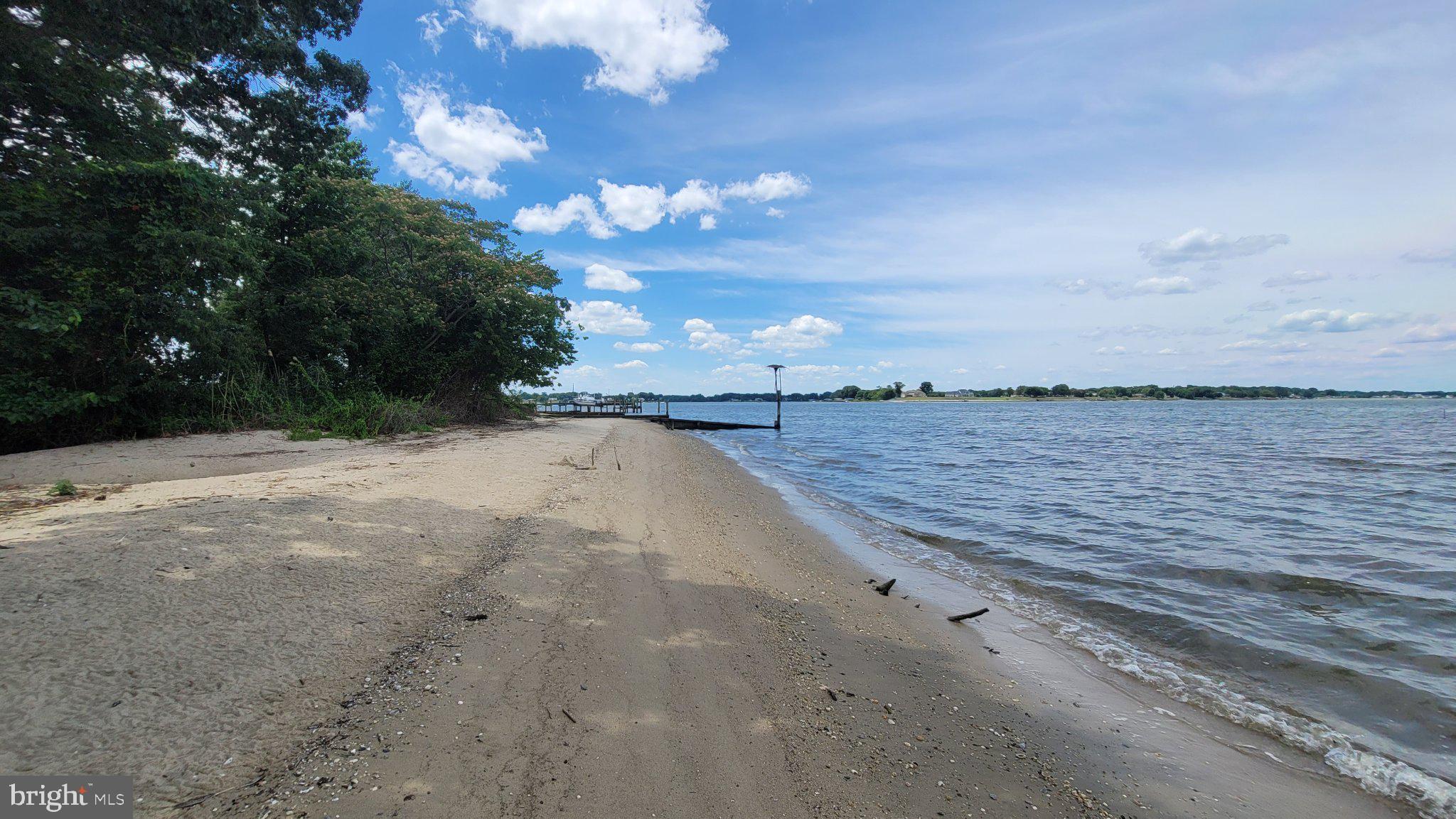 257 Church Point Lane Colonial Beach, VA 22443 - Photo 12 of 25 Serene shoreline under a blue sky.