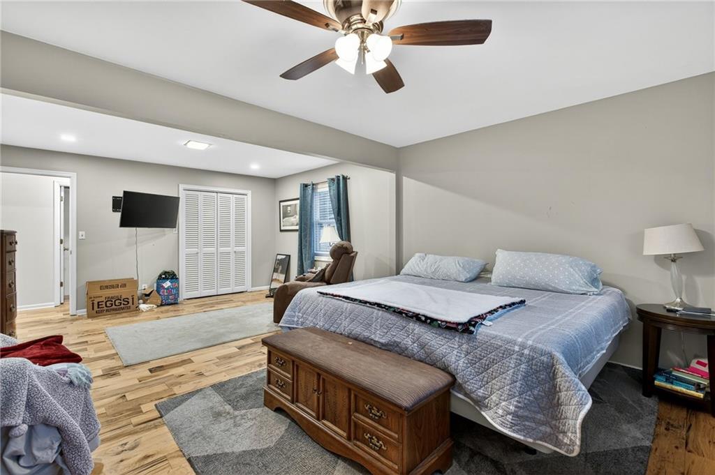 200 Cherry Hill Circle Calhoun, GA 30701 - Photo 22 of 61 a spacious bedroom with a bed a couch and a flat tv screen on the dresser