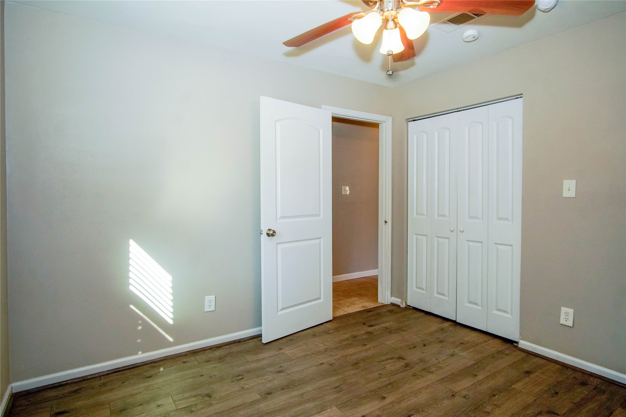 1926 16th Street Hempstead, TX 77445 - Photo 14 of 19 wooden floor in an empty room with a window