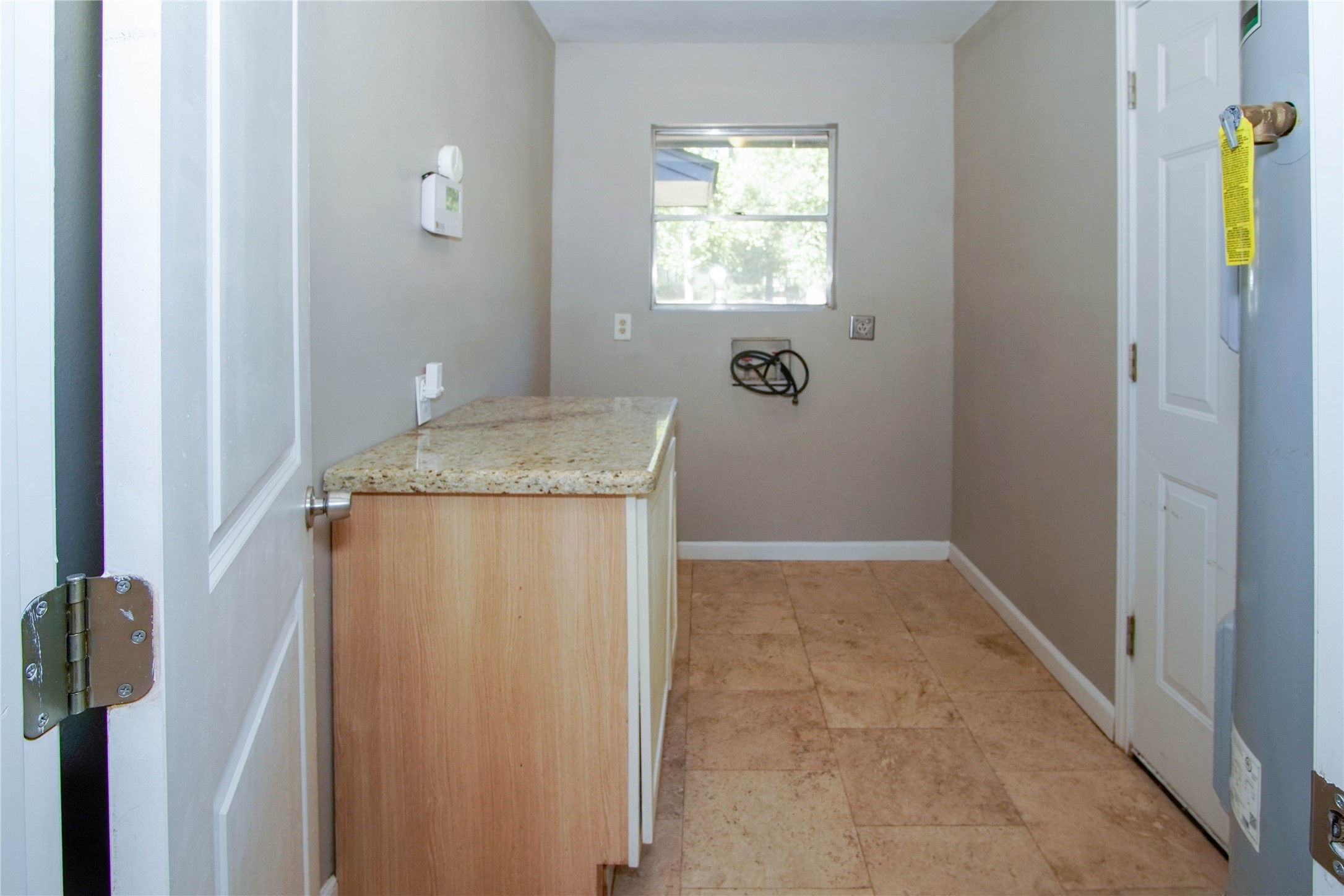 1926 16th Street Hempstead, TX 77445 - Photo 19 of 19 a bathroom with a granite countertop sink and a window