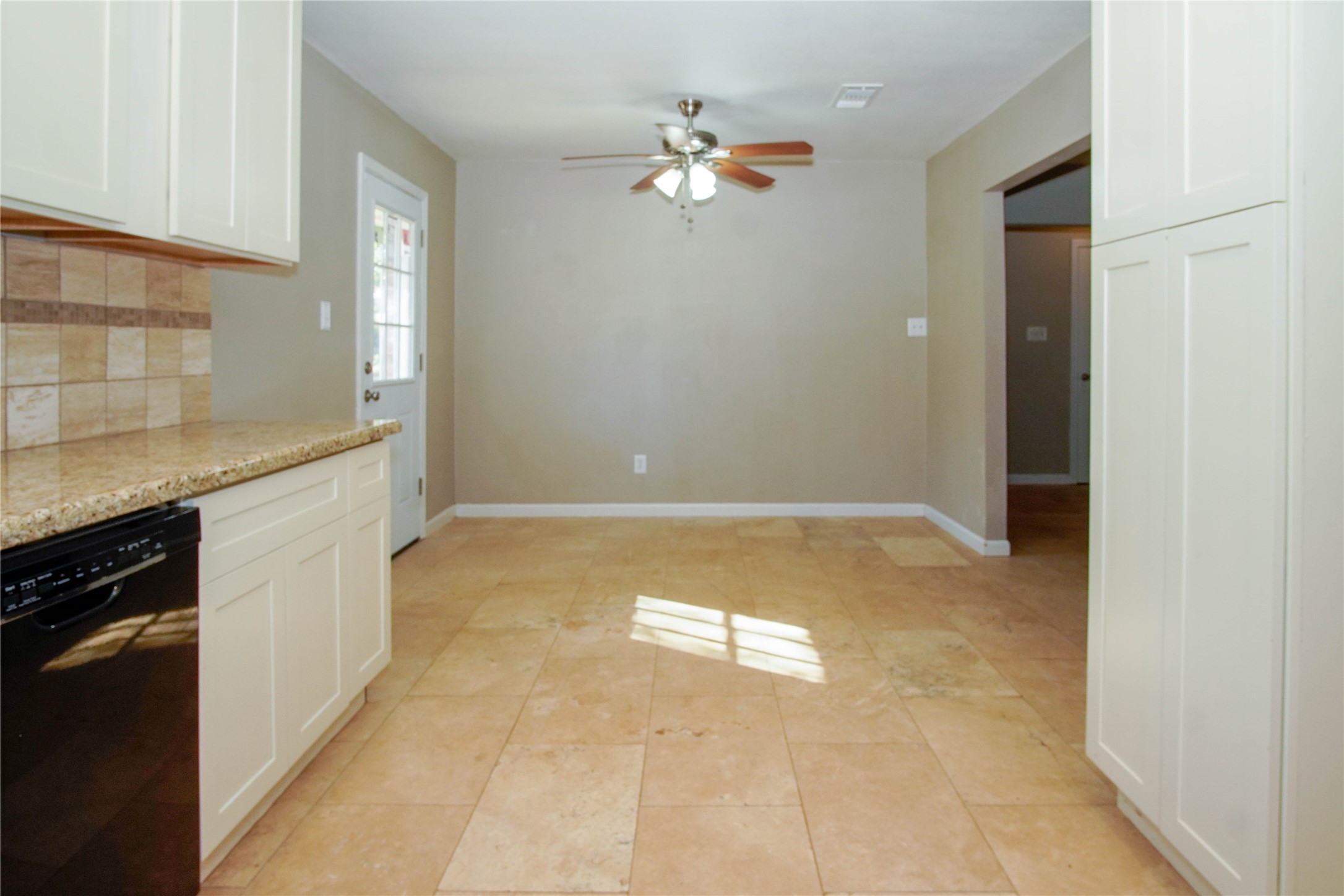 1926 16th Street Hempstead, TX 77445 - Photo 6 of 19 a view of a kitchen with a sink dishwasher a kitchen island a stove a refrigerator with grey cabinets