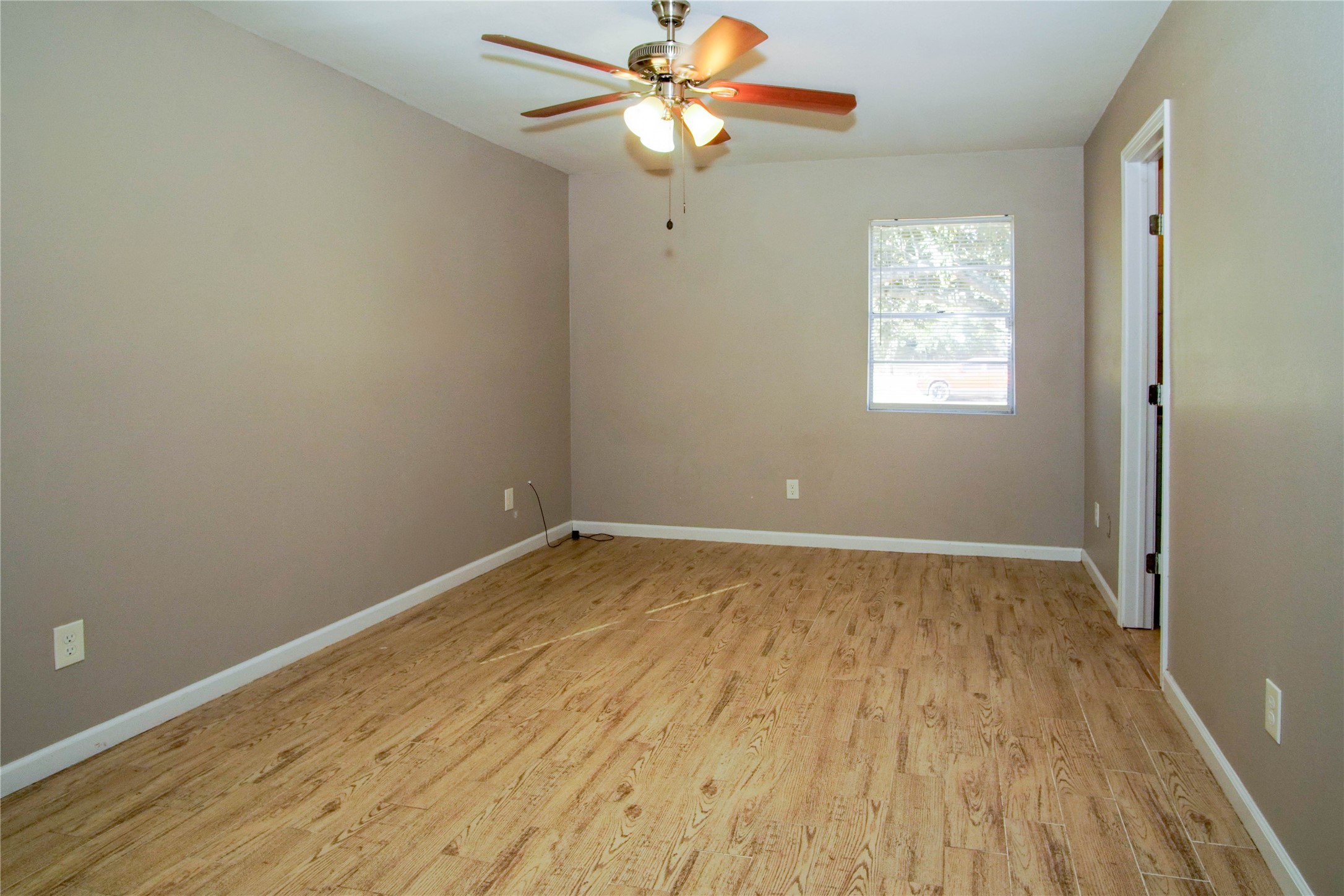 1926 16th Street Hempstead, TX 77445 - Photo 8 of 19 wooden floor in an empty room with a window