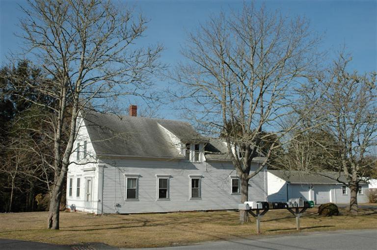 142 Shore Road Bourne, MA 02532 - Photo 3 of 35 a view of a white house with a large tree and wooden fence