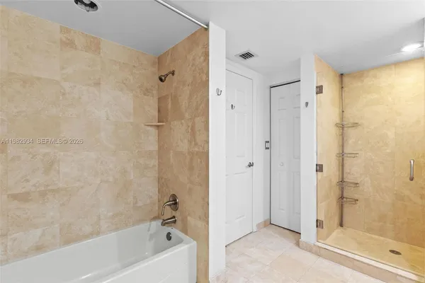 a bathroom with a bathtub shower and a sink