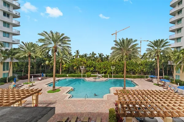 a view of a swimming pool with a patio and a garden