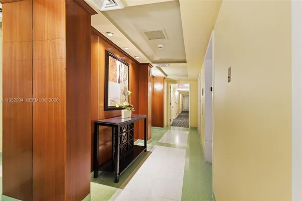 a view of a hallway with a large mirror